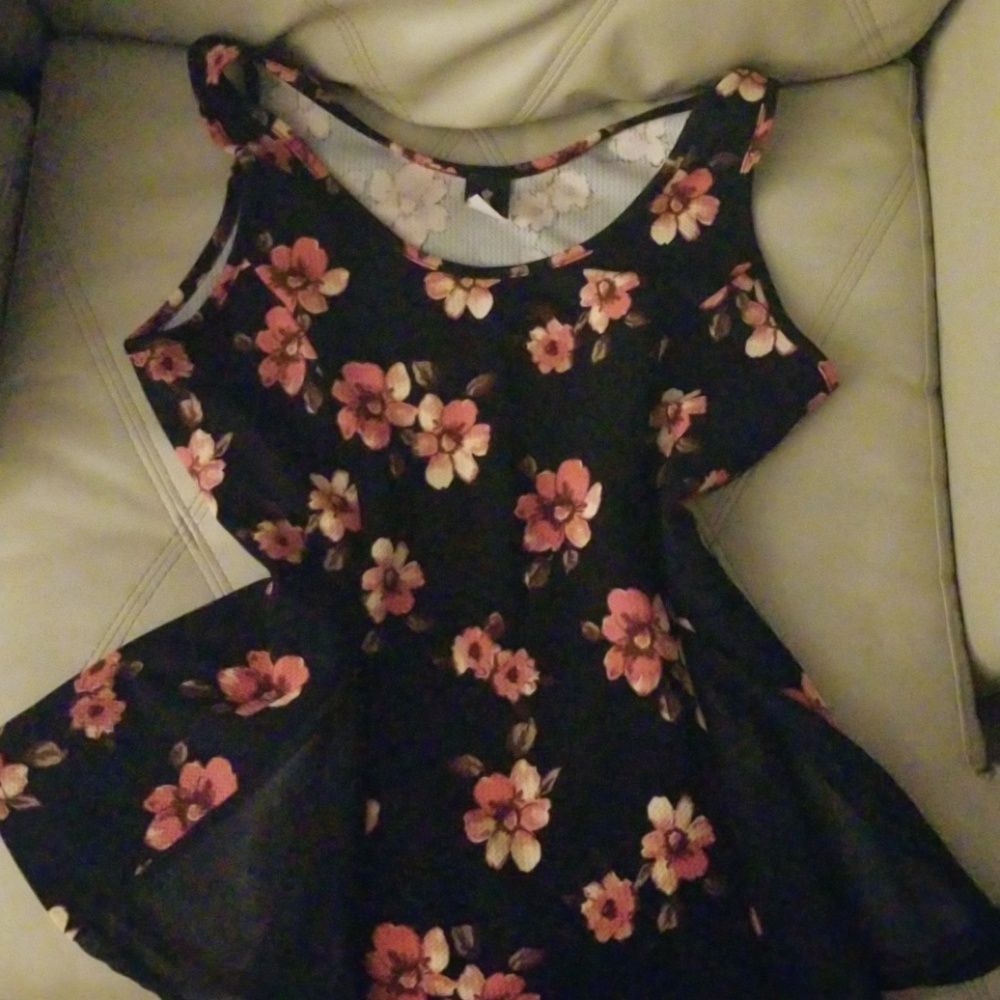 Pink and black floral peplum sleevless top.